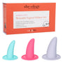 The image showcases the "She-ology™ 3-piece Wearable Vaginal Dilator Set" by Calexotics. This wearable dilator set includes three differently-sized, body-safe silicone dilators in blue, pink, and purple. The packaging emphasizes comfort and ease of mobility, and provides a detailed guide for vaginal dilation.