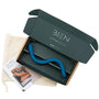 A blue wavy object, identified as The Bien Wave - Pelvic Floor Wand by BIEN Australia, inside an open black cardboard box with the text "BIEN" and a website URL on the lid. Beside the box, there is a beige fabric pouch and a brochure featuring partial imagery of a person along with product usage instructions for pelvic floor muscle training.