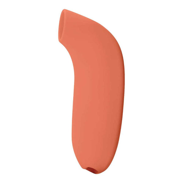 Orange, curved object with a smooth surface crafted from waterproof silicone and featuring a tapered open end, akin to the Dame Aer - External Suction by Dame, reminiscent of a minimalist modern sculpture or device component.