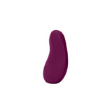 The Dame Pom - External Flexible Vibrator, crafted from medical-grade silicone with a smooth surface, is a small, purple, bean-shaped object displayed against a plain white background.