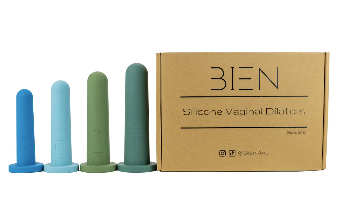 A set of four silicone vaginal dilators in soothing colors (light blue, blue, green, dark green) stand beside a cardboard box labeled "Bien Silicone Vaginal Dilators - Large Set" from BIEN Australia, specifically designed to support women's health through gentle vaginal dilator therapy.