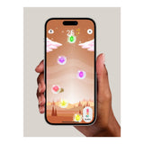 A hand holds a smartphone displaying a colorful game with floating gems and a score of 25. Hills and pink clouds create a surreal backdrop. It's as engaging as Perifit's Perifit Care+ biofeedback tool for pelvic floor strengthening, turning challenges into rewarding adventures.